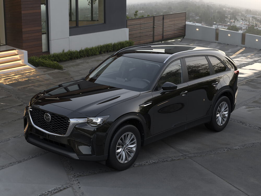 A CX-90 parked outside a home in the hills.