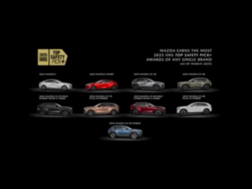 Showroom floor featuring all Mazda car models in either red or grey. 