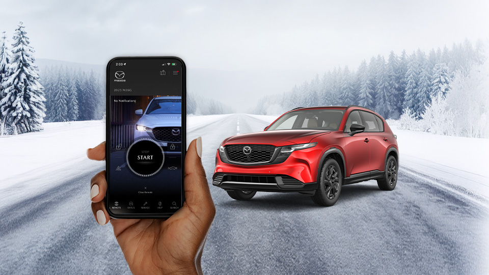 A hand holding a cellphone with the MyMazda app open