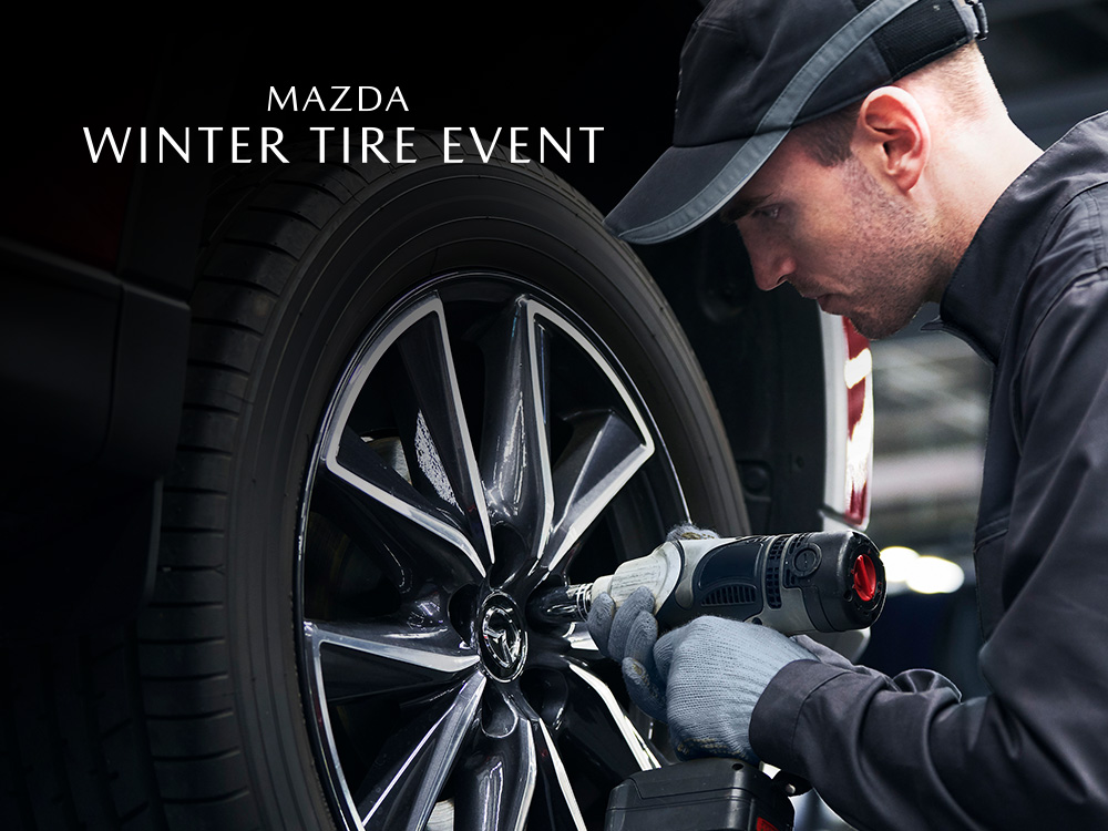 Mazda technician tightening lug nuts on wheel of vehicle