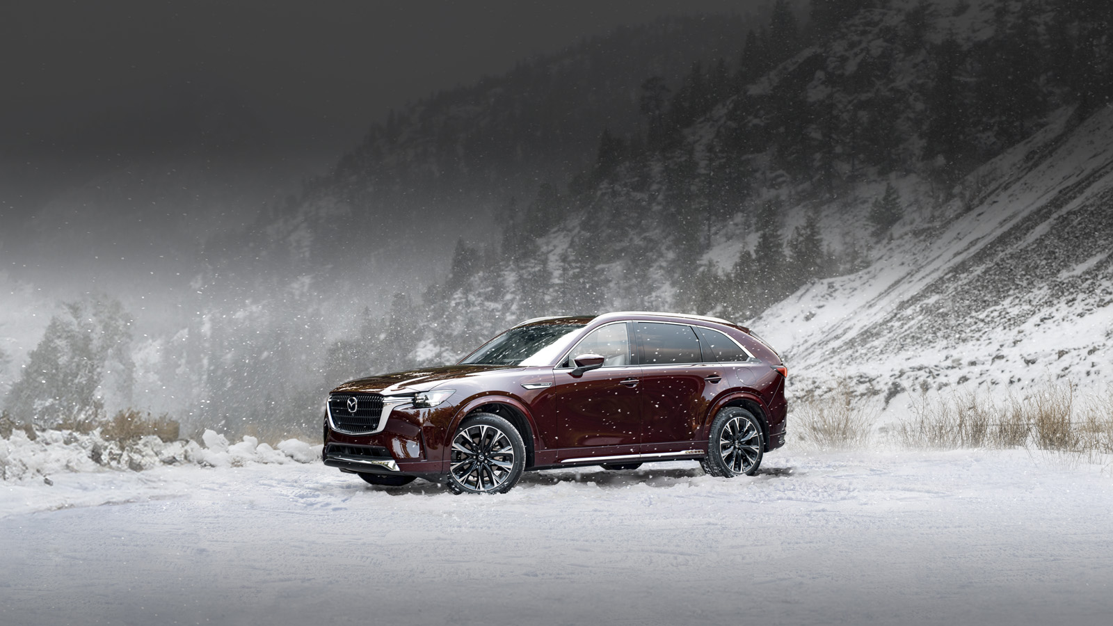 A Mazda CX-90 driving on a snowy road