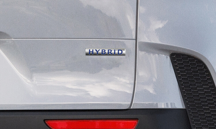 Close up of ‘Hybrid’ badge on right side rear liftgate of Wind Chill Pearl Mazda CX-50 Hybrid.