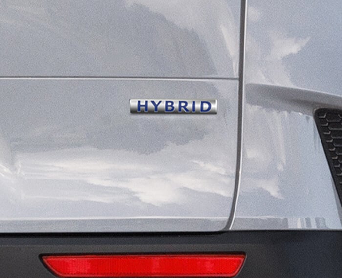 Close up of ‘Hybrid’ badge on right side rear liftgate of Wind Chill Pearl Mazda CX-50 Hybrid.