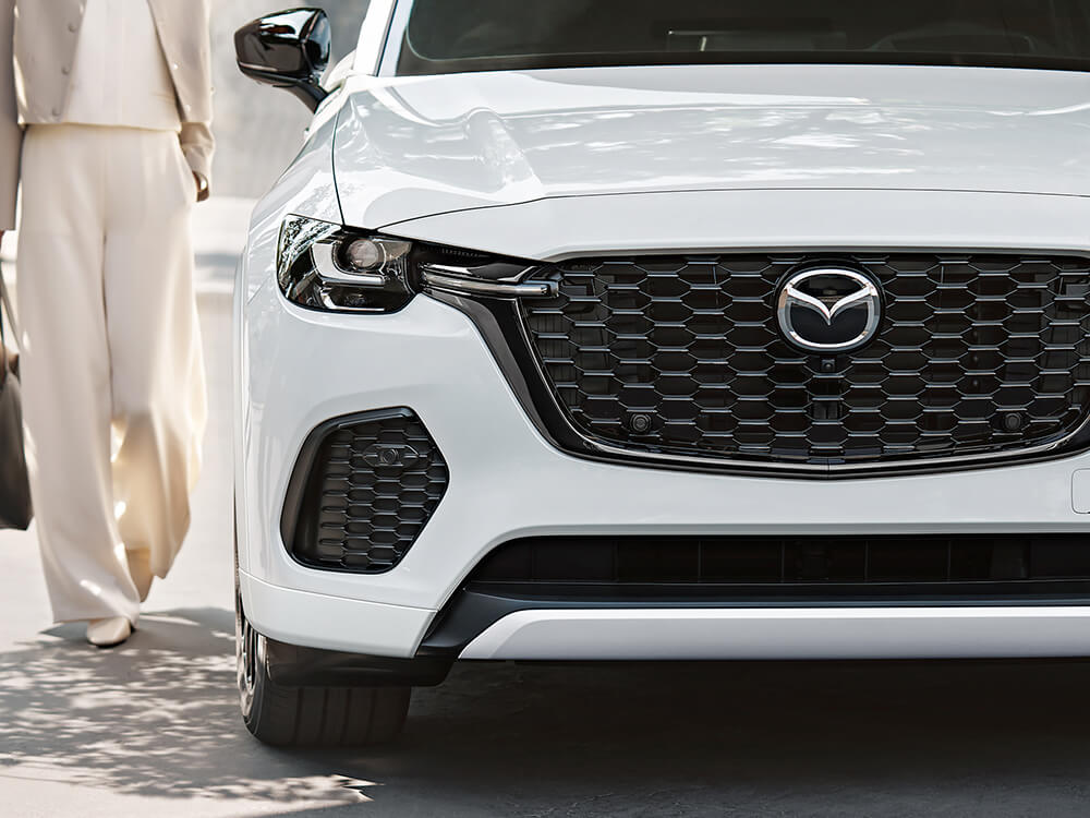 Closeup of the front, passenger’s side on the CX-70 PHEV, a passenger approaches the door.