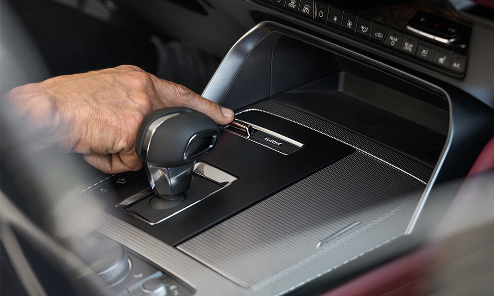 Closeup of HMI commander control in the CX-70’s cockpit, a hand touches a button to activate Mi-Drive.