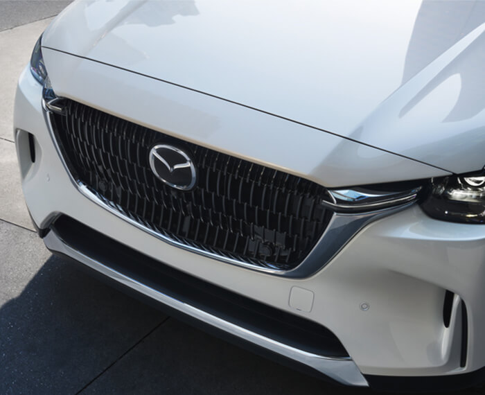 Close-up of Arctic white CX-90 front grille. 