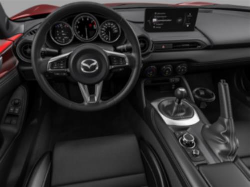 View of the interior cabin of an MX-5 ST with steering wheel and dashboard.