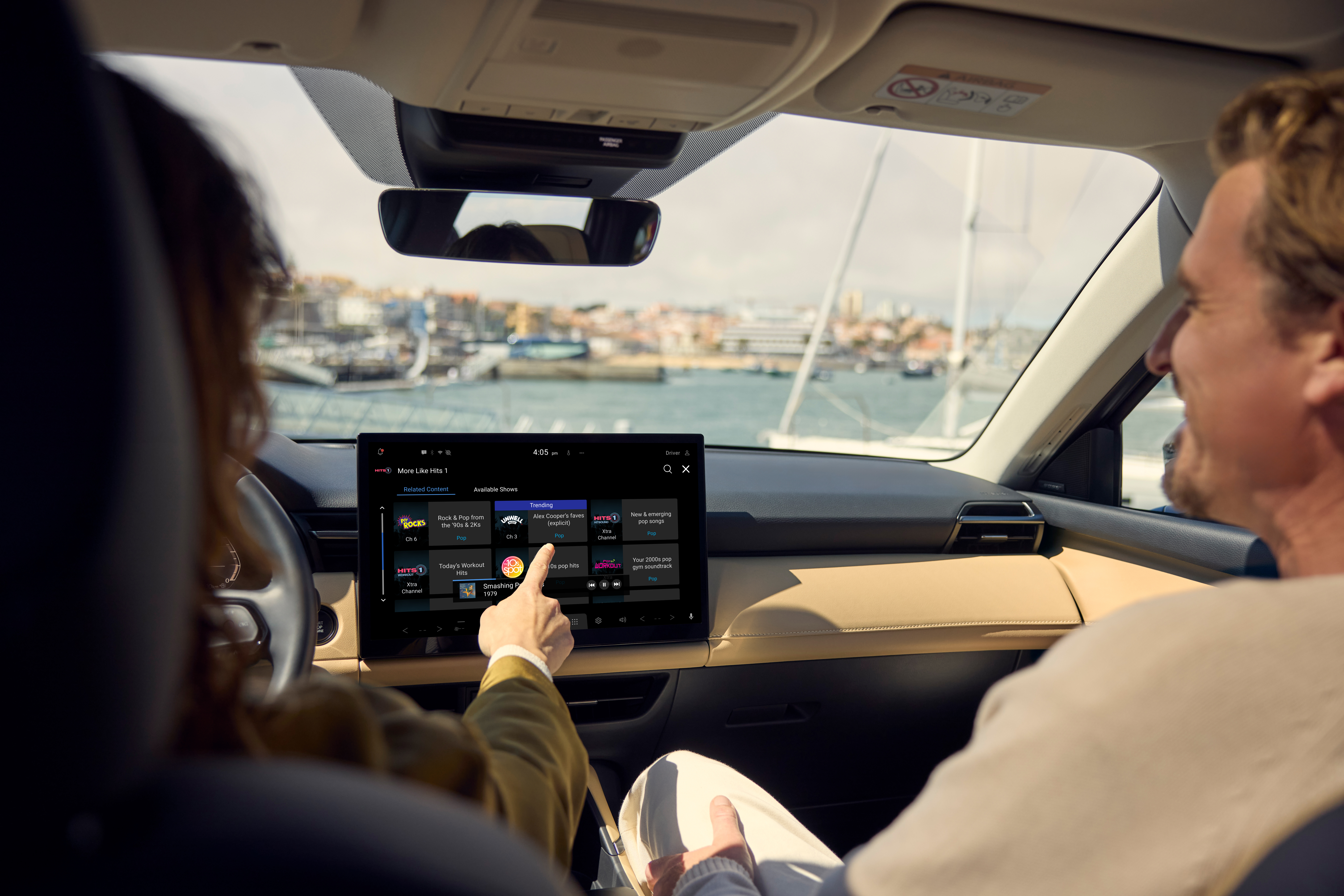 View from behind of two people in the front seats, with the centre display showing Google Maps navigation