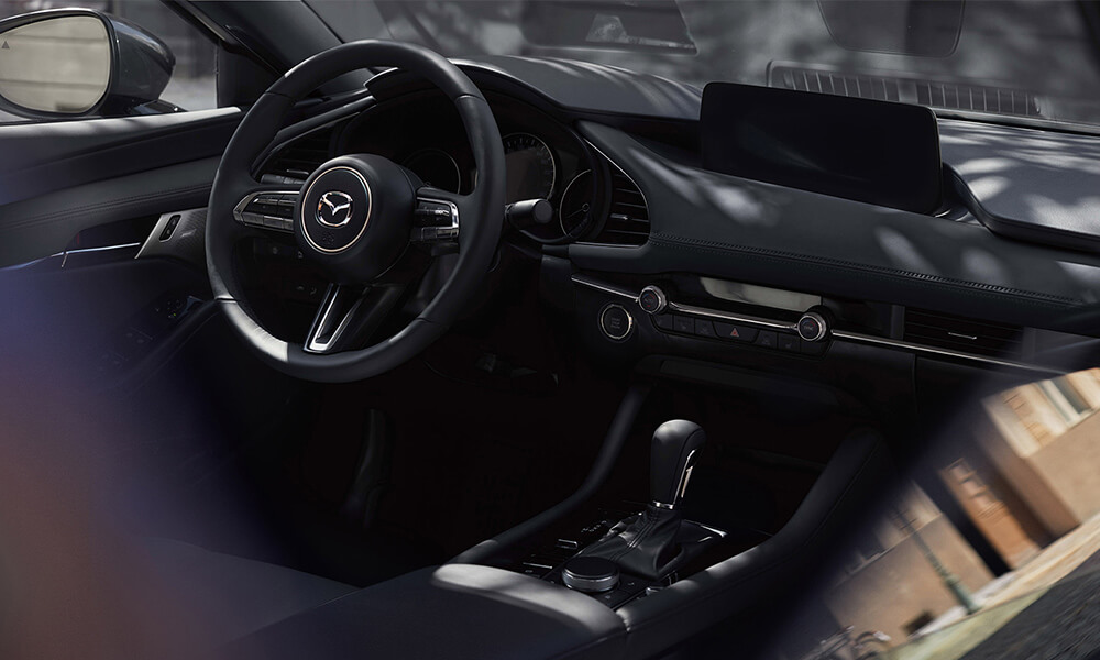 Mazda3 interior from the open front passenger-side window looking in.